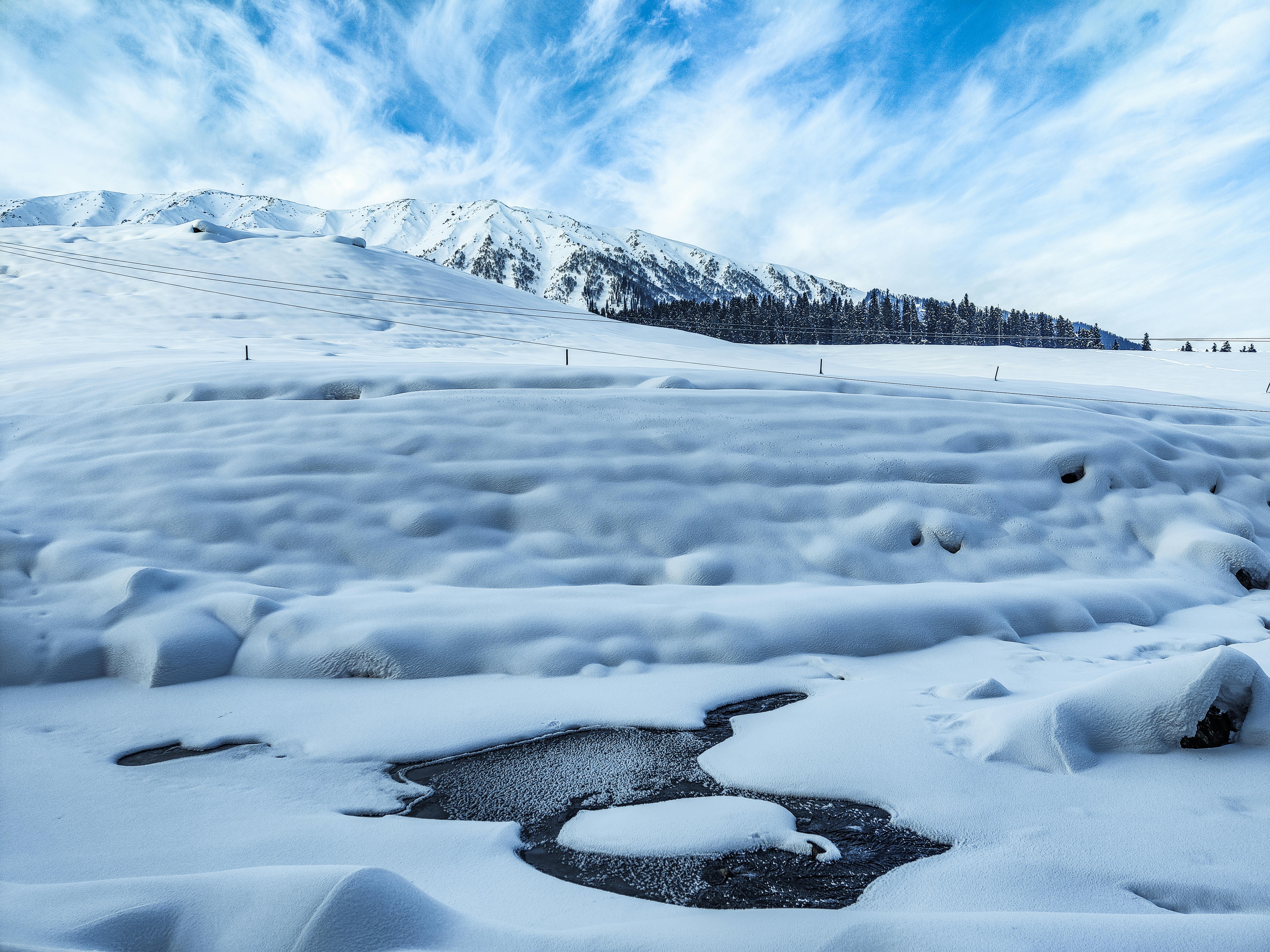 Snowy terrain near frozen lake